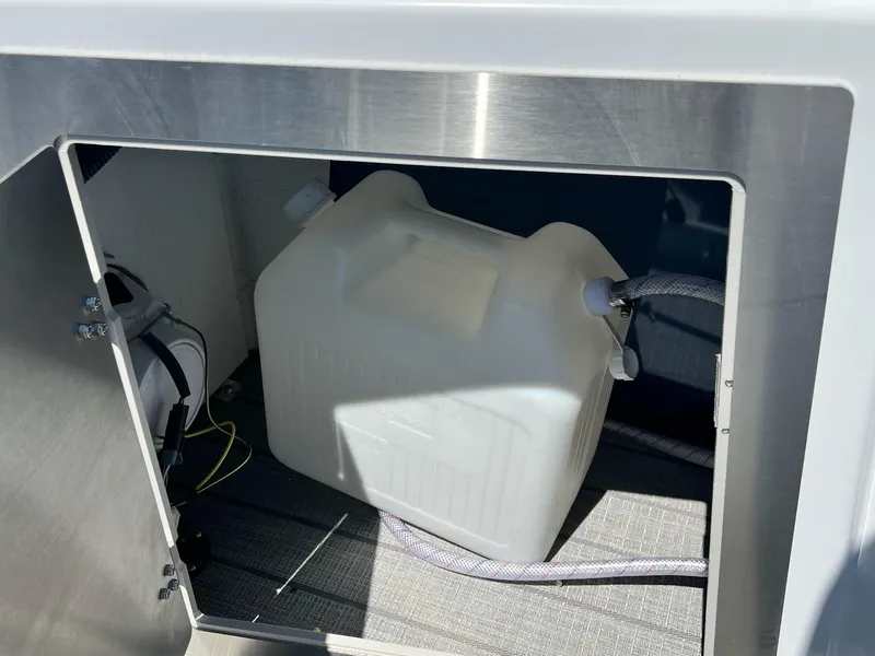 Slide: The Image of Storage compartment of 2024 Sylvan S3 CLZ DH Tritoon with water container. - 25
