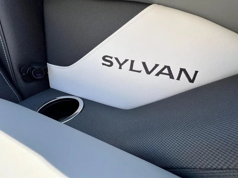 Slide: The Image of 2024 Sylvan S3 CLZ DH Tritoon interior with logo and cup holder. - 28