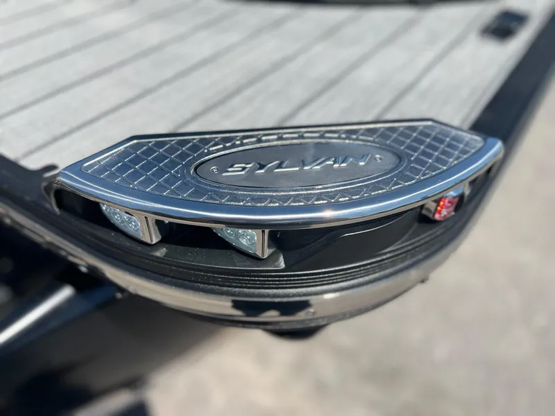 Slide: The Image of Close-up of 2024 Sylvan S3 CLZ DH Tritoon boat deck with logo and lights. - 36