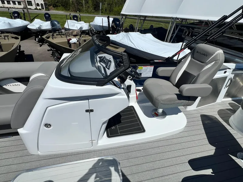 Slide: The Image of 2024 Sylvan S3 CLZ DH Tritoon boat cockpit with captain's chair and control console. - 37