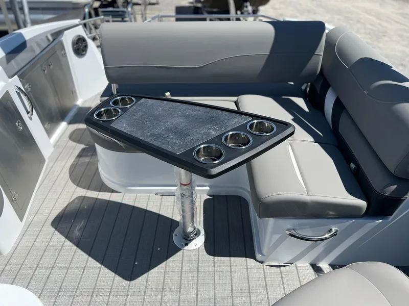 Slide: The Image of 2024 Sylvan S3 CLZ DH Tritoon boat interior with seating and table. - 4