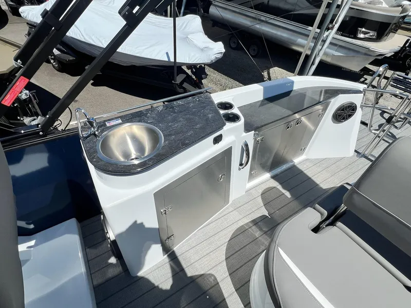 Slide: The Image of 2024 Sylvan S3 CLZ DH Tritoon boat with onboard sink and storage cabinets. - 46