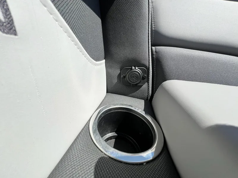 Slide: The Image of Close-up of 2024 Sylvan S3 CLZ DH Tritoon interior with USB port and cup holder. - 5