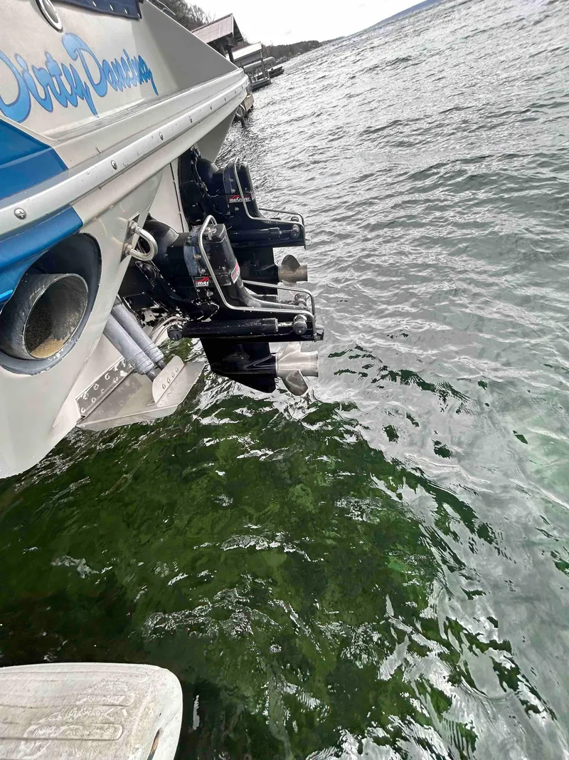 Slide: The Image of 1987 Sea Ray Pachanga 32 boat stern in water with dual outboard motors. - 10