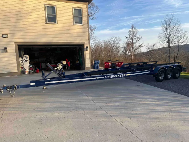 Slide: The Image of Loadmaster boat trailer for 1987 Sea Ray Pachanga 32 parked in driveway. - 11