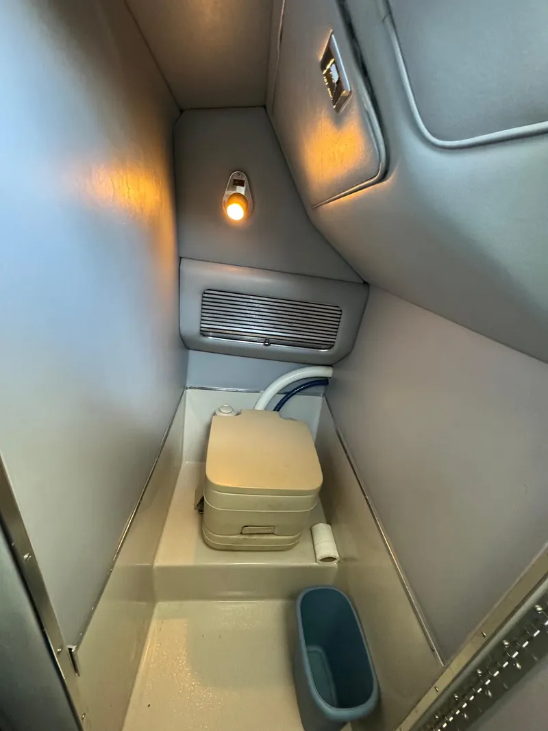 Slide: The Image of Compact bathroom in 1987 Sea Ray Pachanga 32 boat with portable toilet and light. - 12