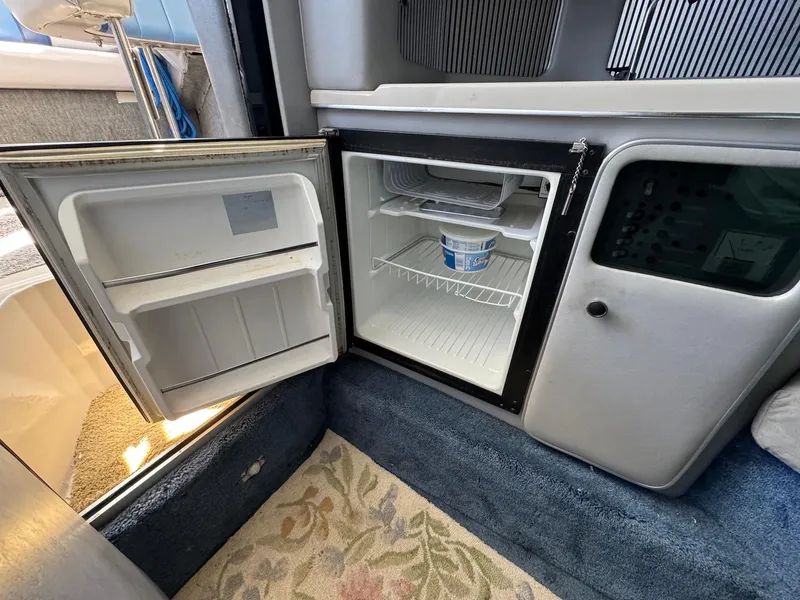 Slide: The Image of Open mini fridge inside 1987 Sea Ray Pachanga 32 boat cabin. - 13