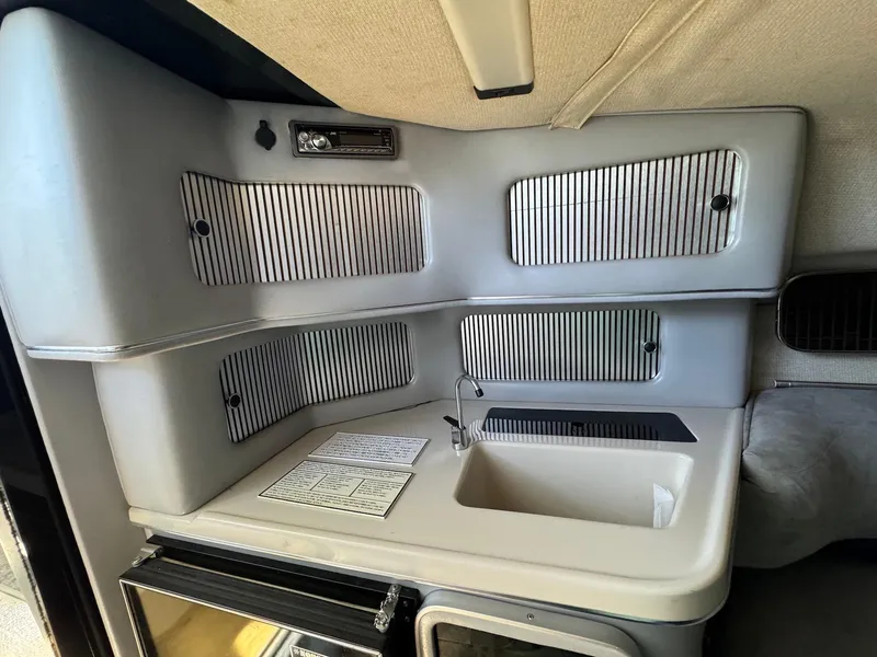 Slide: The Image of 1987 Sea Ray Pachanga 32 boat interior with sink and storage compartments. - 17