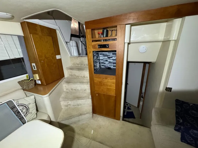 Slide: The Image of Interior of 1987 Sea Ray Pachanga 32 boat with stairs, seating, and wooden cabinetry. - 23