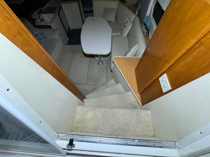 Slide: The Image of Interior of 1987 Sea Ray Pachanga 32 boat with stairs leading to seating area. - 25