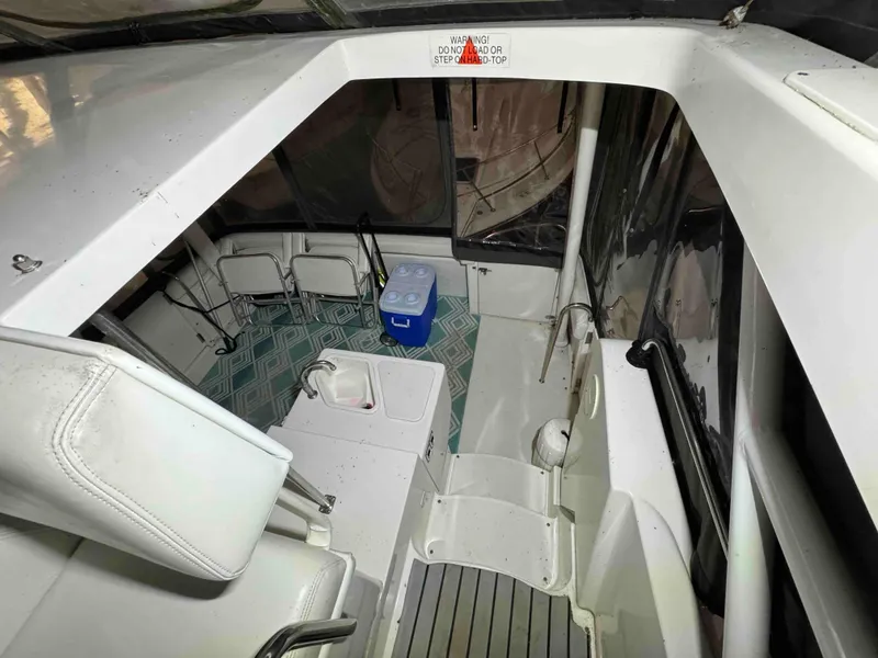 Slide: The Image of 1987 Sea Ray Pachanga 32 boat interior with seating and cooler. - 26