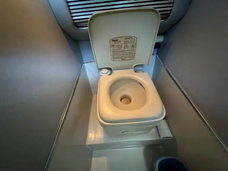 Slide: The Image of 1987 Sea Ray Pachanga 32 boat toilet in compact bathroom. - 27