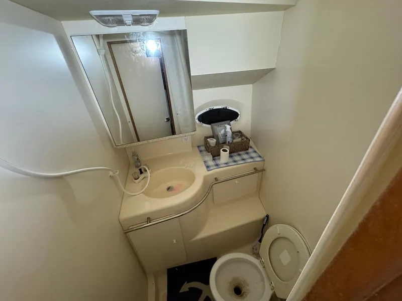 Slide: The Image of 1987 Sea Ray Pachanga 32 boat bathroom with sink, mirror, and toilet. - 28