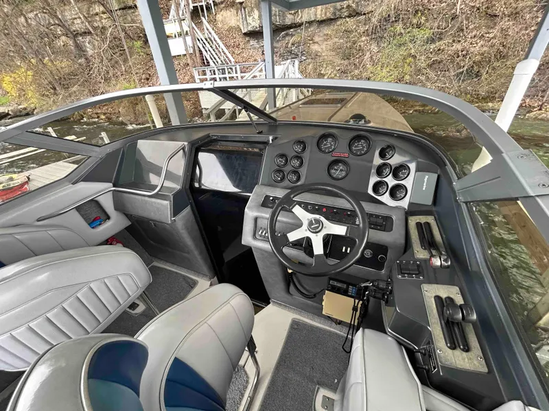 Slide: The Image of 1987 Sea Ray Pachanga 32 boat cockpit with steering wheel and control panel. - 4