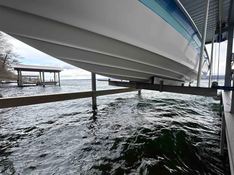 Slide: The Image of 1987 Sea Ray Pachanga 32 boat on a lift over water. - 5