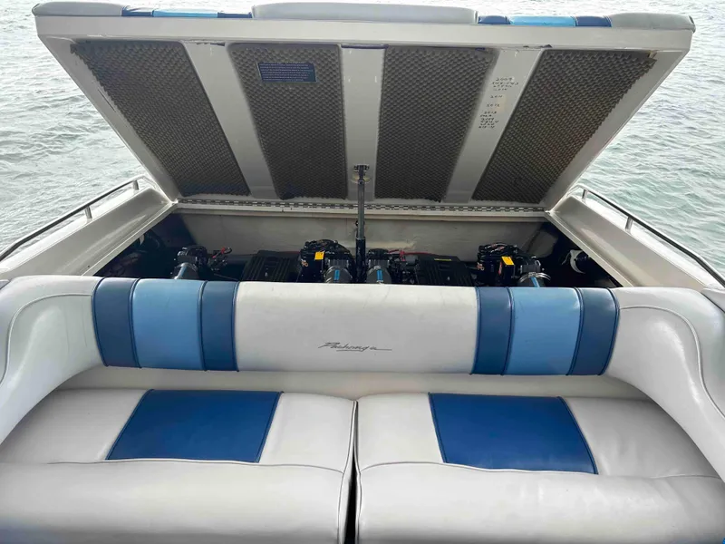 Slide: The Image of 1987 Sea Ray Pachanga 32 boat with open engine compartment and blue-white seating. - 7