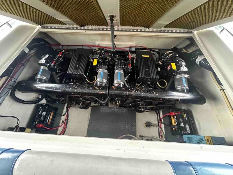 Slide: The Image of 1987 Sea Ray Pachanga 32 engine compartment with dual engines and wiring. - 8