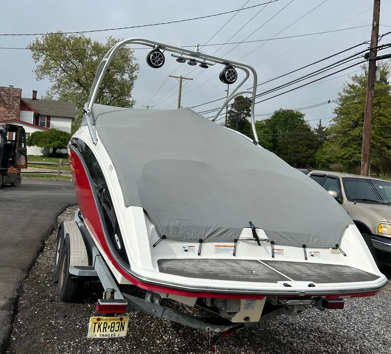 Slide: The Image of 2012 Yamaha Boats AR240 on trailer with cover, rear view. - 2