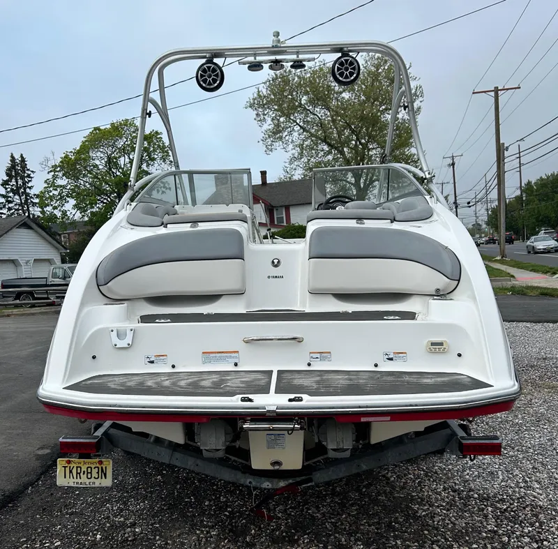 Slide: The Image of 2012 Yamaha Boats AR240 rear view on trailer, white and gray upholstery, outdoor setting. - 3