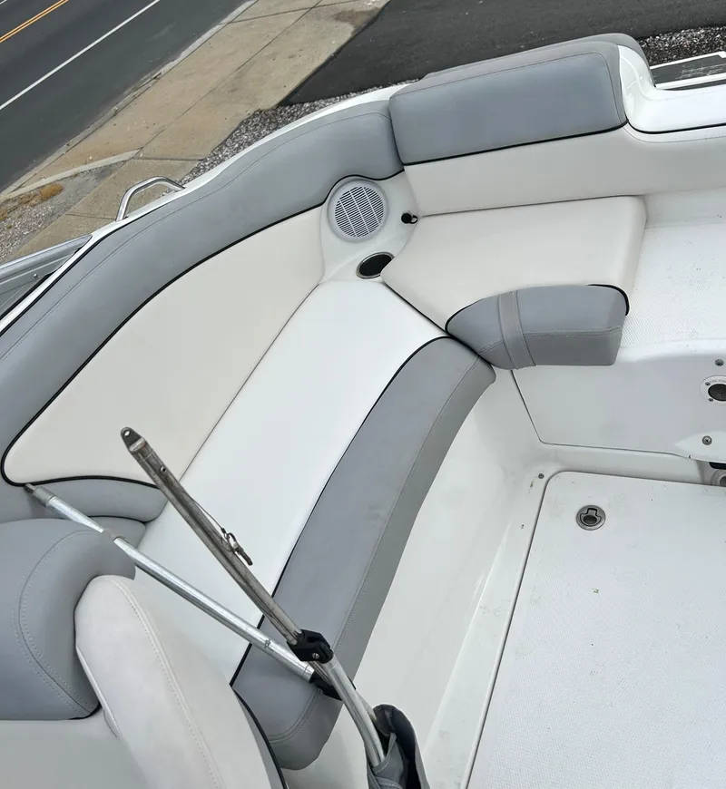 Slide: The Image of 2012 Yamaha Boats AR240 interior seating with gray and white upholstery. - 7