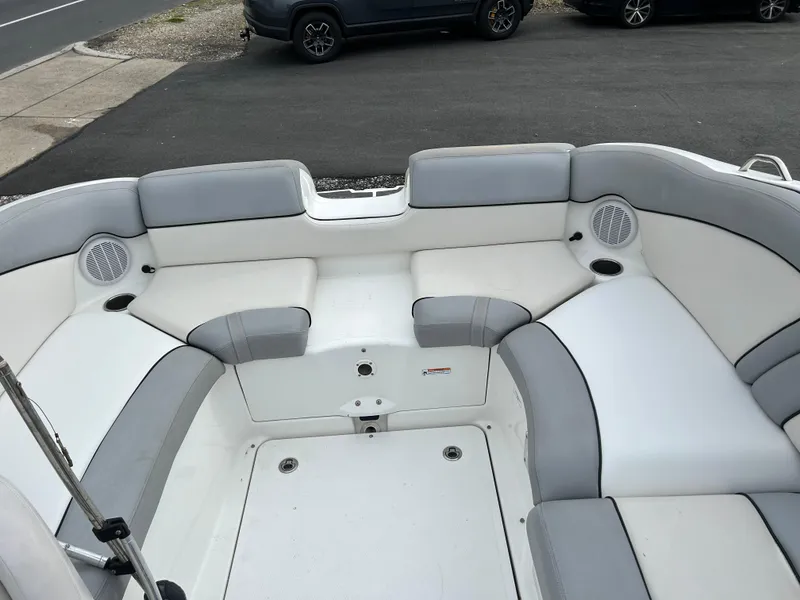 Slide: The Image of 2012 Yamaha Boats AR240 interior seating area with gray and white upholstery. - 9