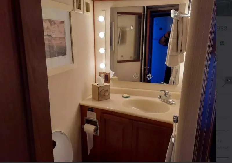Slide: The Image of Bathroom interior of 1988 Viking 41 Convertible yacht with vanity and mirror. - 13