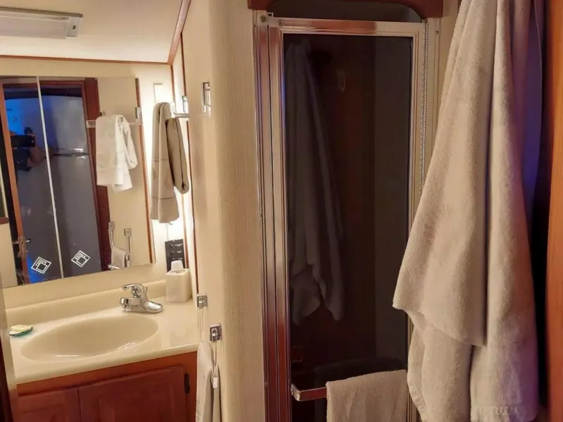 Slide: The Image of 1988 Viking 41 Convertible bathroom with sink, mirror, and shower. - 14