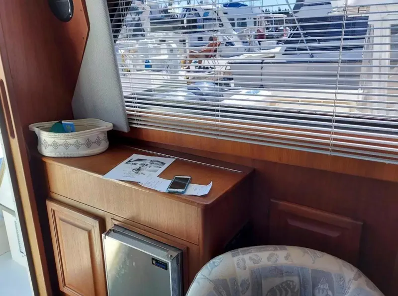 Slide: The Image of Interior of 1988 Viking 41 Convertible yacht with wooden cabinetry and window blinds. - 15