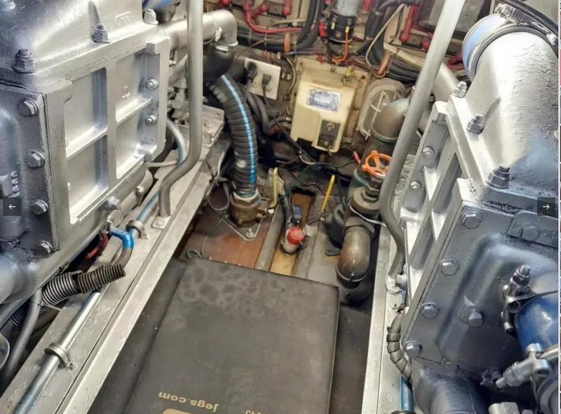 Slide: The Image of Engine room of a 1988 Viking 41 Convertible boat with visible machinery. - 17