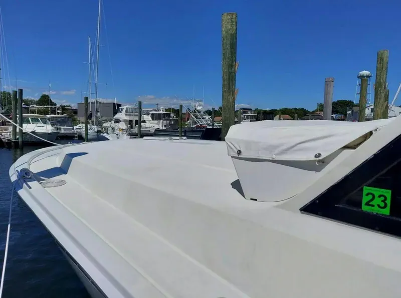Slide: The Image of 1988 Viking 41 Convertible boat docked at a marina on a sunny day. - 3