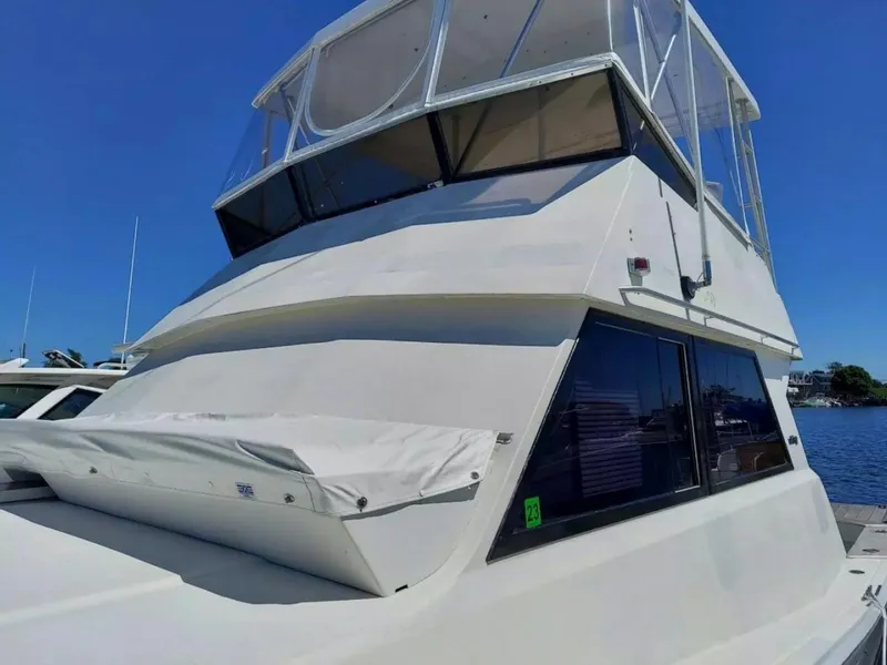 Slide: The Image of 1988 Viking 41 Convertible yacht with flybridge, docked on a sunny day. - 4