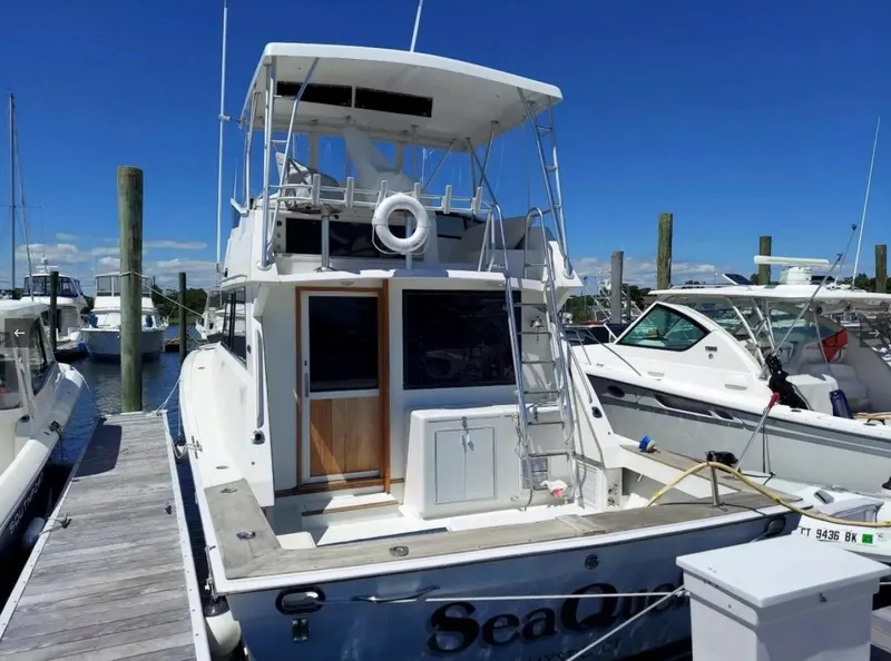 Slide: The Image of 1988 Viking 41 Convertible yacht docked at marina on a sunny day. - 6