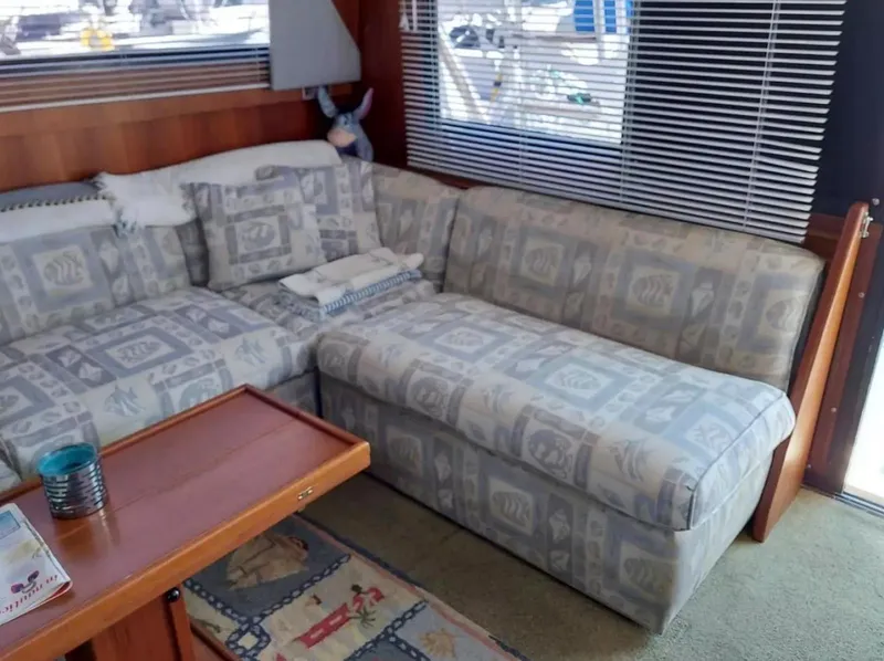 Slide: The Image of Cozy interior of a 1988 Viking 41 Convertible with patterned sofa and wooden accents. - 8