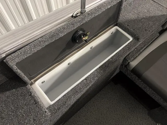 Slide: The Image of 2024 Lund 1775 Impact XS Sport boat interior storage compartment. - 13