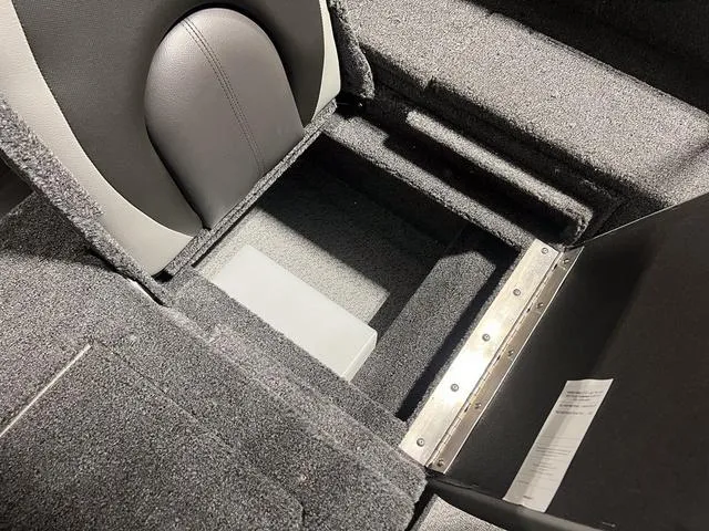Slide: The Image of 2024 Lund 1775 Impact XS Sport boat interior storage compartment. - 16