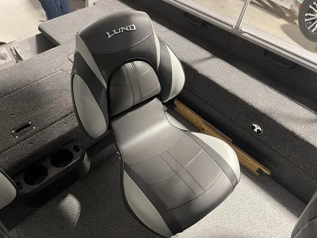 Slide: The Image of 2024 Lund 1775 Impact XS Sport boat interior with black and gray seating. - 19
