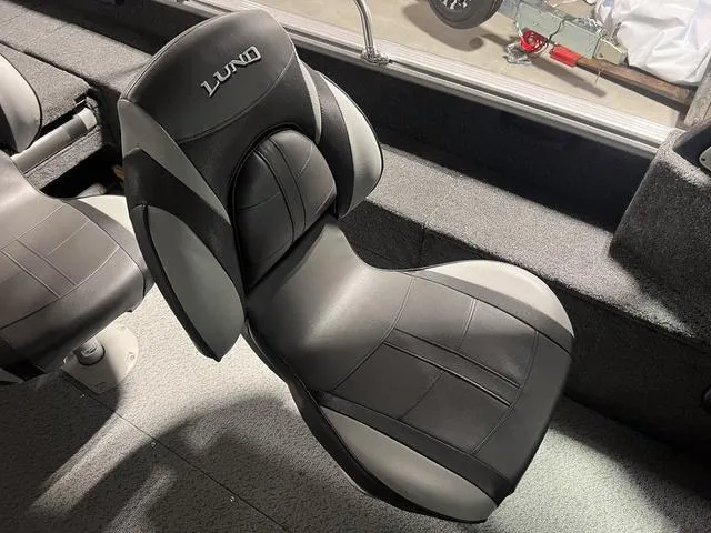 Slide: The Image of 2024 Lund 1775 Impact XS Sport boat seat, black and gray upholstery. - 20