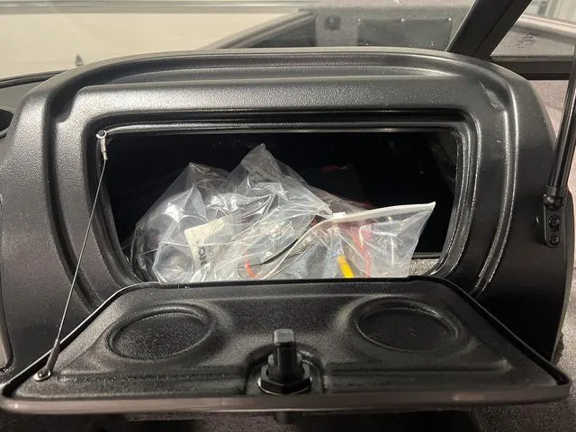 Slide: The Image of 2024 Lund 1775 Impact XS Sport glove compartment with storage items. - 22