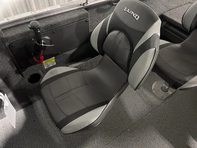 Slide: The Image of 2024 Lund 1775 Impact XS Sport boat interior with black and gray seating. - 23