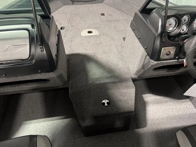 Slide: The Image of 2024 Lund 1775 Impact XS Sport boat interior with carpeted deck and console. - 25