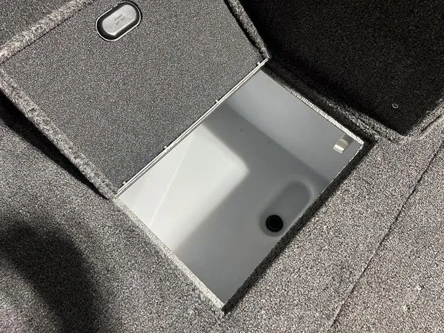 Slide: The Image of 2024 Lund 1775 Impact XS Sport storage compartment with open lid. - 30