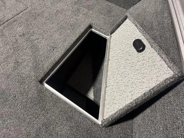 Slide: The Image of 2024 Lund 1775 Impact XS Sport storage compartment with open hatch. - 31