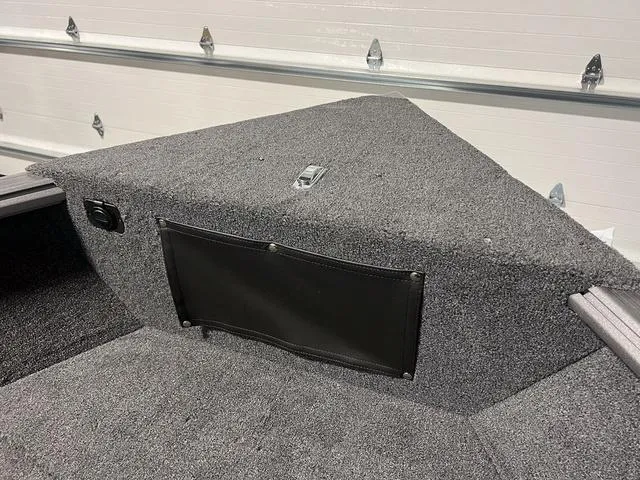 Slide: The Image of 2024 Lund 1775 Impact XS Sport boat interior with carpeted storage compartment. - 32