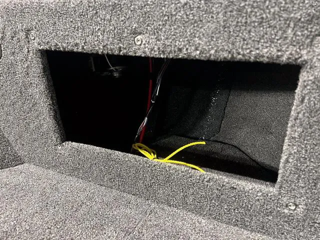 Slide: The Image of 2024 Lund 1775 Impact XS Sport boat storage compartment with wiring. - 33