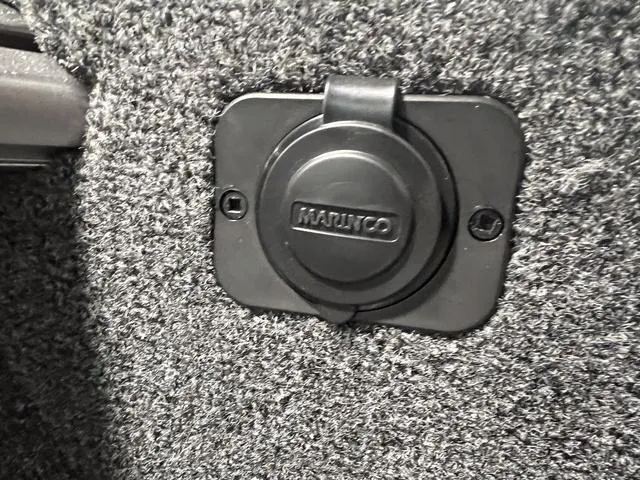 Slide: The Image of Close-up of a Marinco power outlet on a 2024 Lund 1775 Impact XS Sport boat. - 34