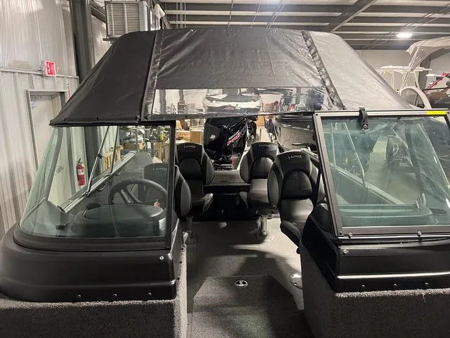 Slide: The Image of 2024 Lund 1775 Impact XS Sport boat interior with canopy in a showroom. - 36
