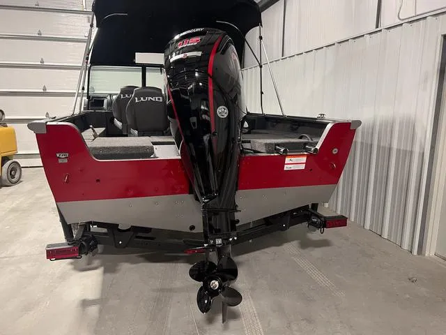 Slide: The Image of 2024 Lund 1775 Impact XS Sport boat with Mercury outboard motor in a garage. - 6