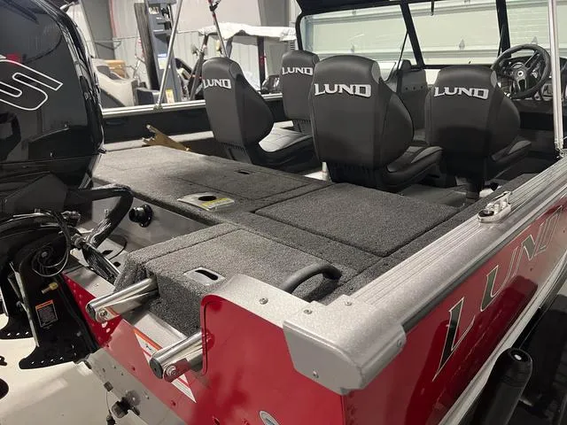 Slide: The Image of 2024 Lund 1775 Impact XS Sport boat interior with seating and motor. - 8