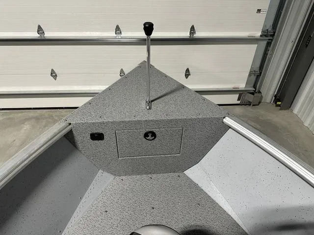 Slide: The Image of 2024 Lund 1875 Alaskan SS boat interior with control lever and storage compartment. - 12