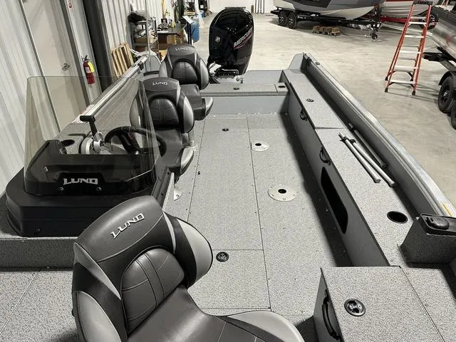 Slide: The Image of 2024 Lund 1875 Alaskan SS fishing boat interior with seating and steering console. - 13